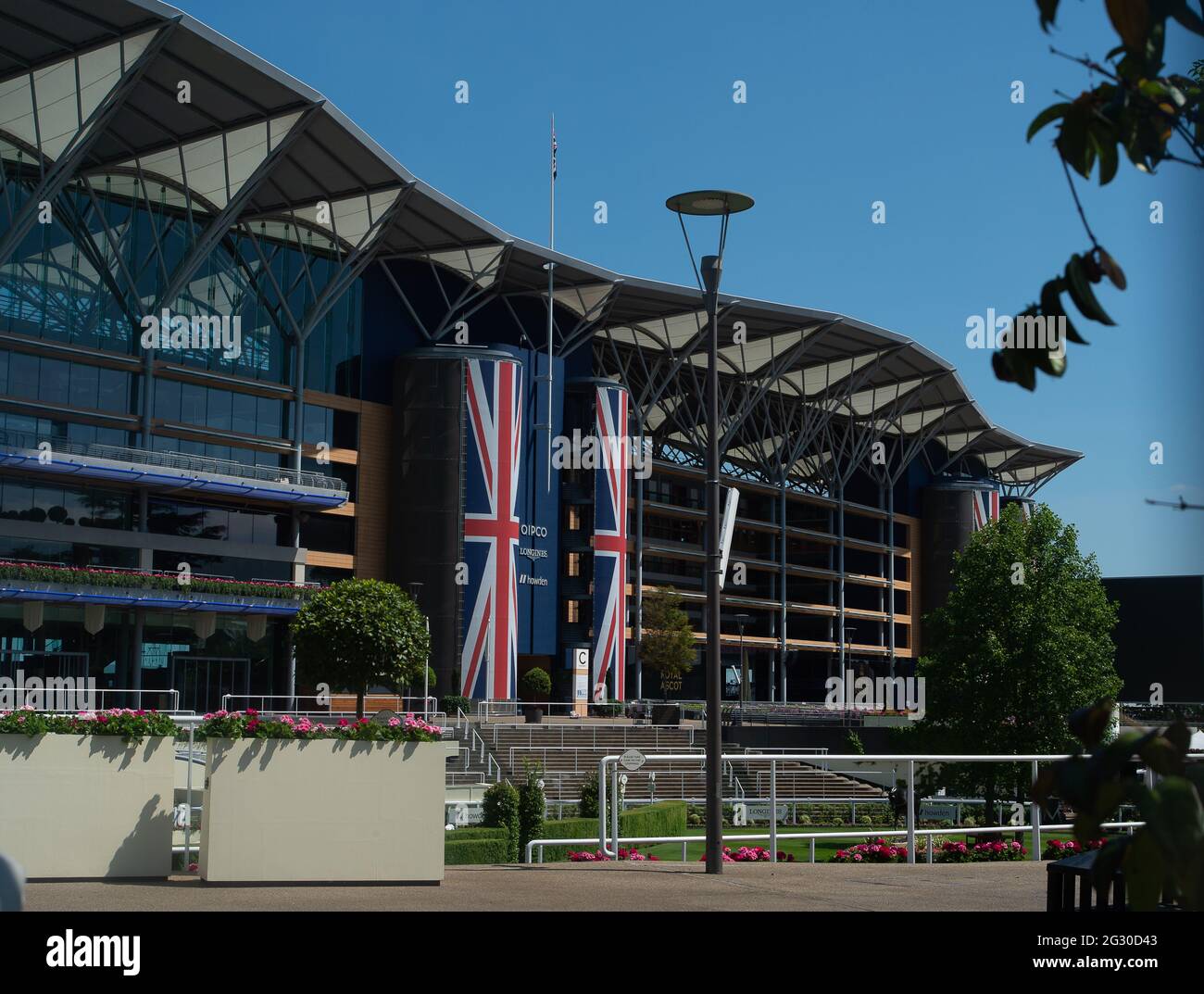 Ascot, Berkshire, UK. 13th June, 2021. The Grandstand at Ascot Racecourse. Preparations are well underway for the world famous Royal Ascot racing event. Racing fans are delighted to be able to return to Royal Ascot this year, however, due to the ongoing Covid-19 lockdown restrictions, the number of guests are limited to 12,000 ticketed guests each day. Racegoers will also be required to produce a negative Covid-19 test. Credit: Maureen McLean/Alamy Stock Photo