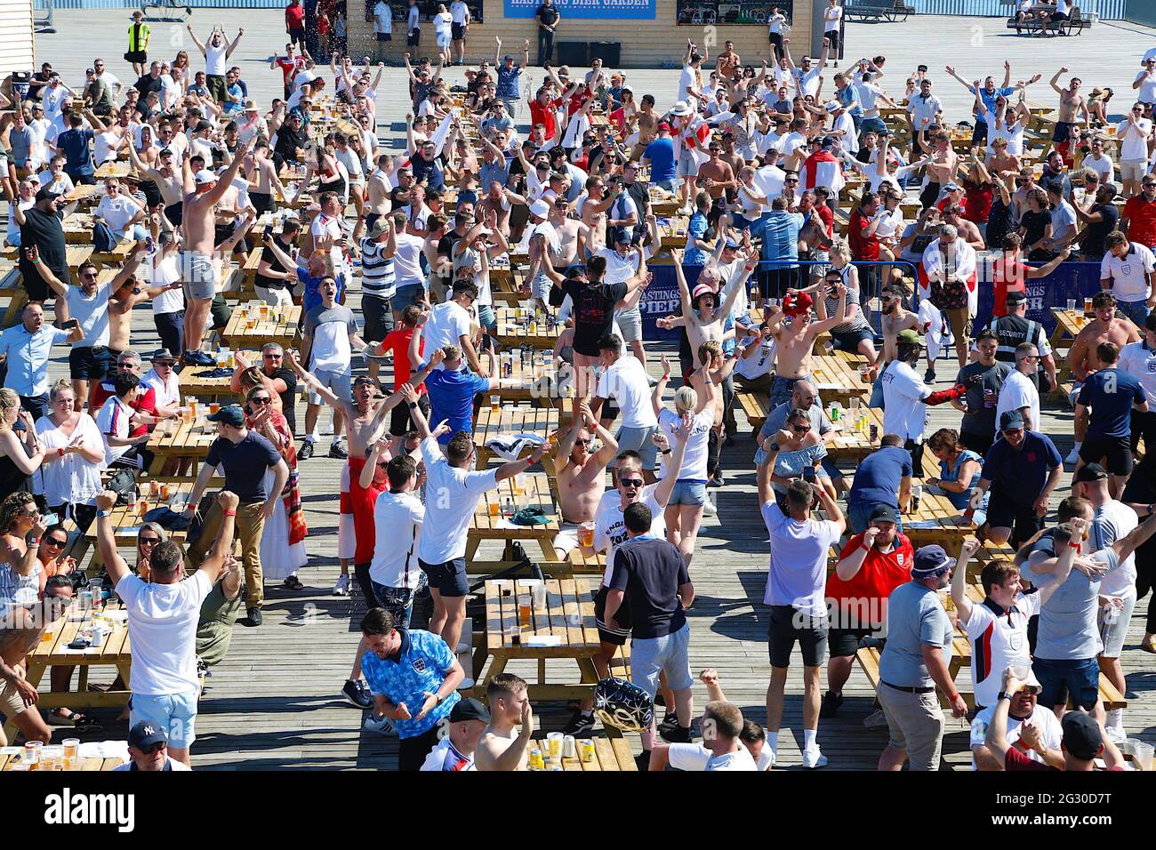 Hastings, East Sussex, UK. 13 June, 2021. England fans drink outside in the sunny weather on the Hastings pier fan zone that has provided a large screen and beer bar. England fans celebrate winning the football match 1 - 0 Photo Credit: Paul Lawrenson /Alamy Live News Stock Photo