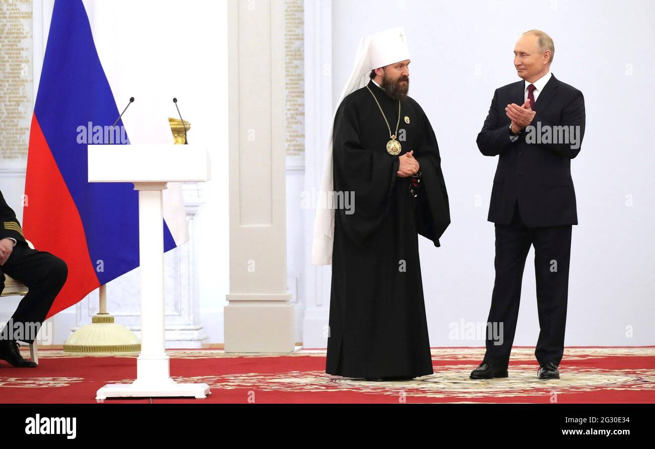 Moscow, Russia. 12th June, 2021. Russian President Vladimir Putin chats with Metropolitan Hilarion of Volokolamsk Grigory Alfeyev during the National Awards ceremony to celebrate Russia Day at Saint Georges Hall in the Grand Kremlin Palace June 12, 2021 in Moscow, Russia. Credit: Planetpix/Alamy Live News Stock Photo