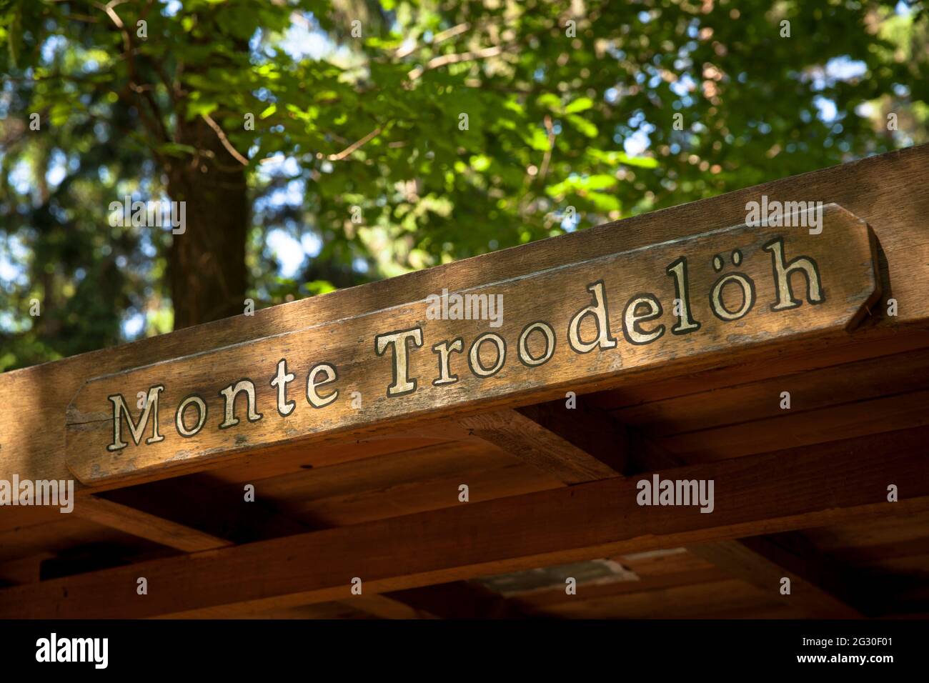 sign on a covered bench of Monte Troodeloeh in the Koenigsforest in Cologne, here is the highest natural height of the city with 118.04 m above sea le Stock Photo