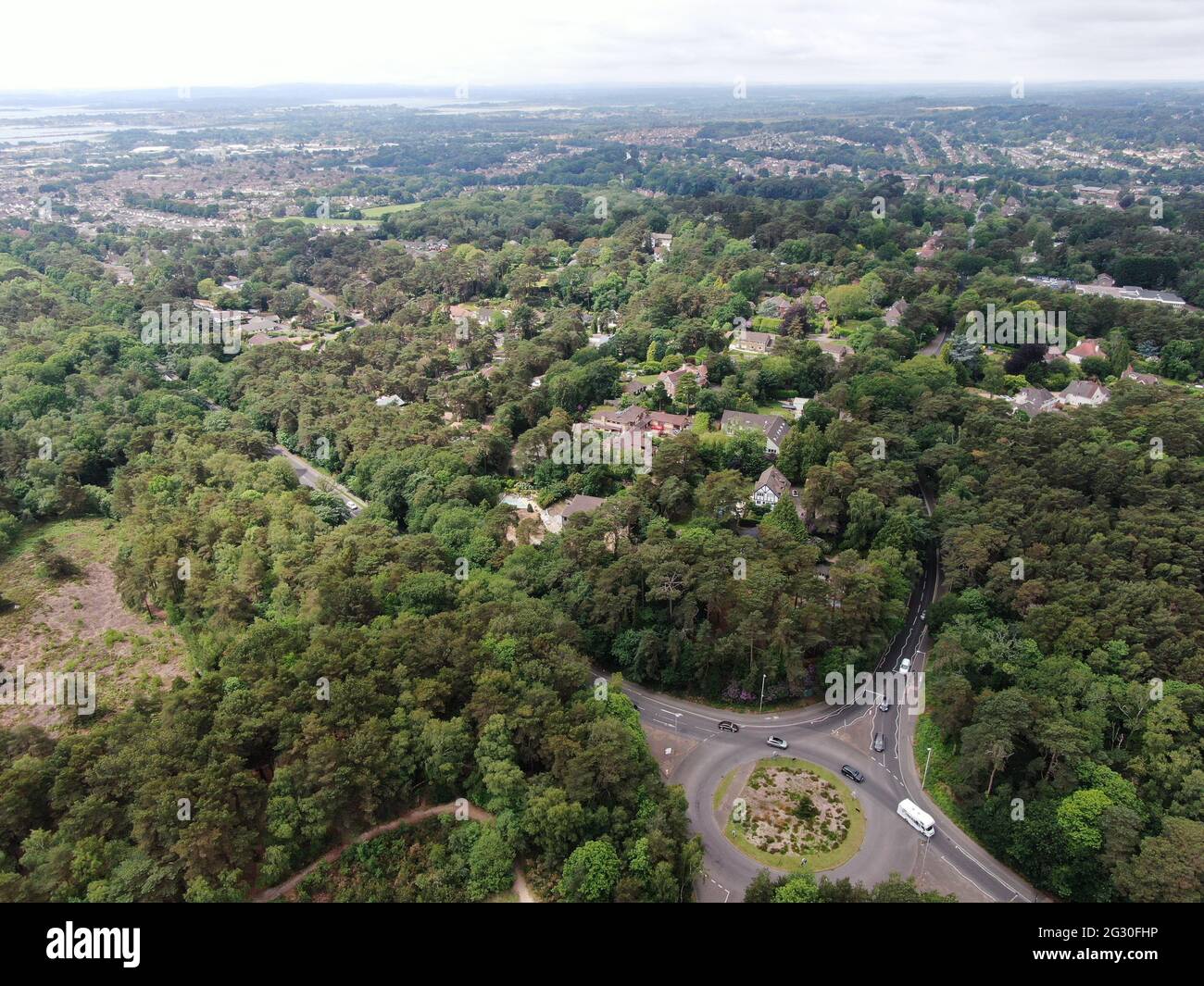 aerial view of a road roundabout set in a wooded and heathland area in Dorset Stock Photo