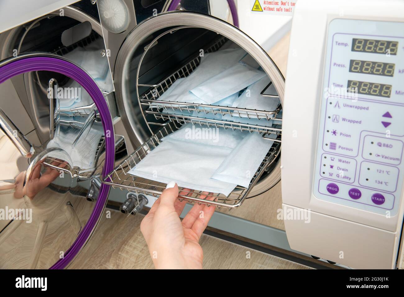Sterilizing medical instruments in autoclave in dental office Stock