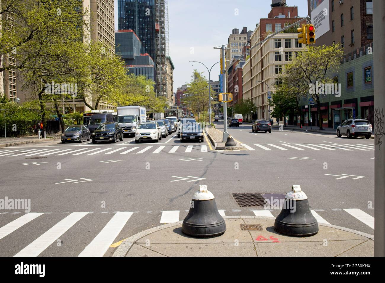 New York, NY, USA - June 12, 2021: Barriers protecting pedestrians standing on traffic islands on Houston Street Stock Photo