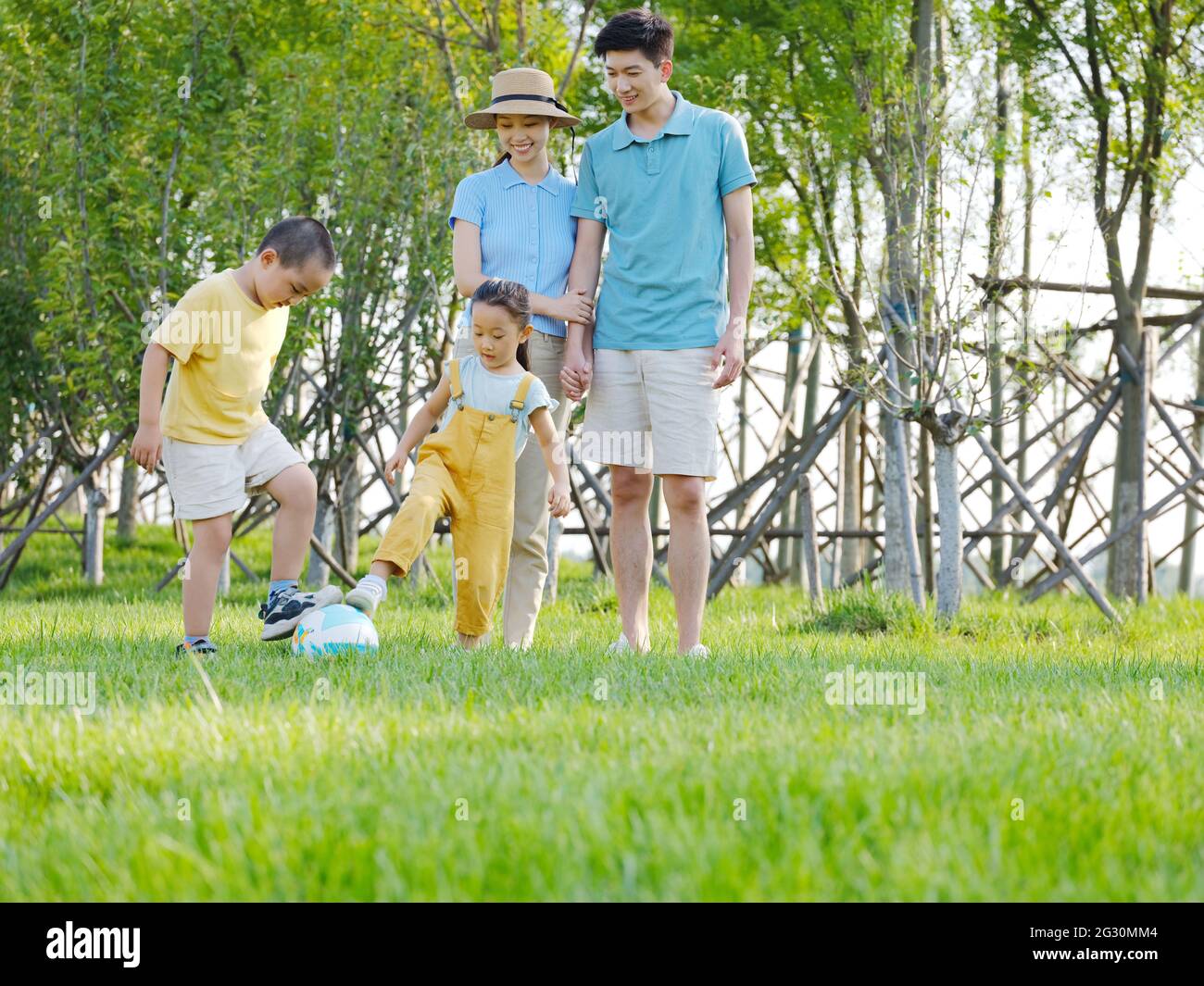 Happy family of four playing in the park high quality photo Stock Photo ...
