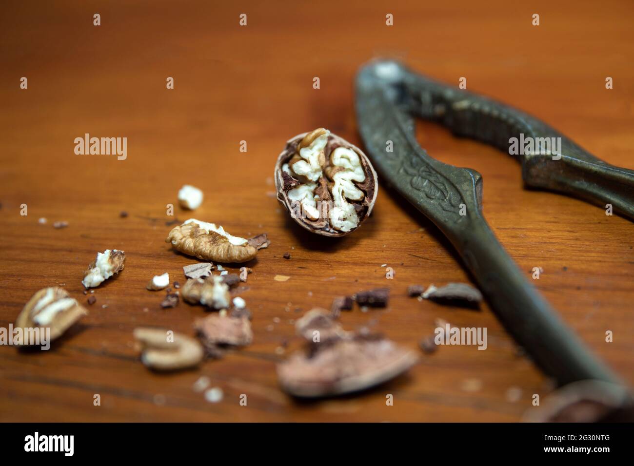 Vintage Nut Cracker with pecan nuts on a wood table Stock Photo