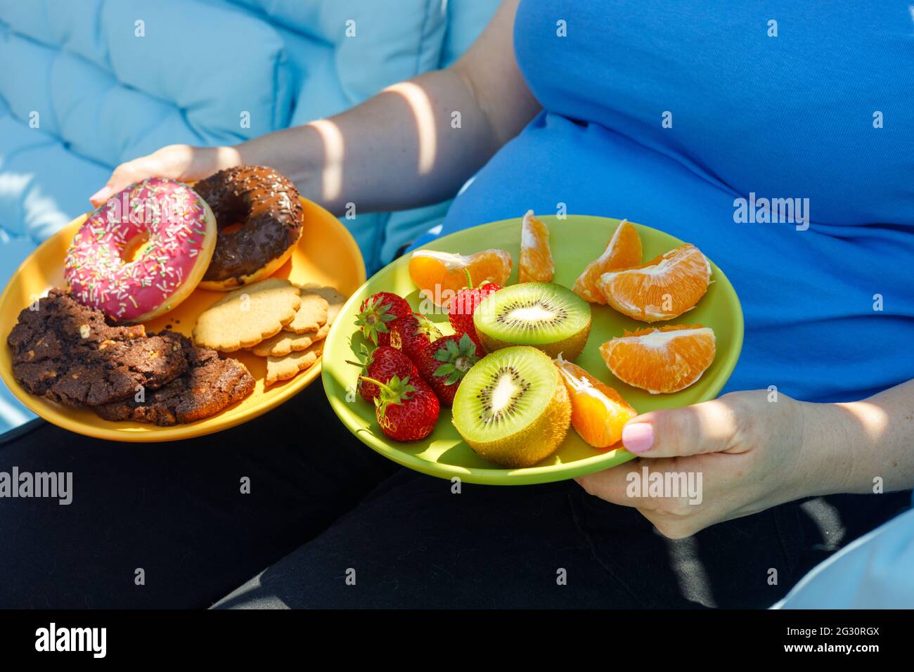 Concept of healthy and unhealthy food. The woman offers a choice of two