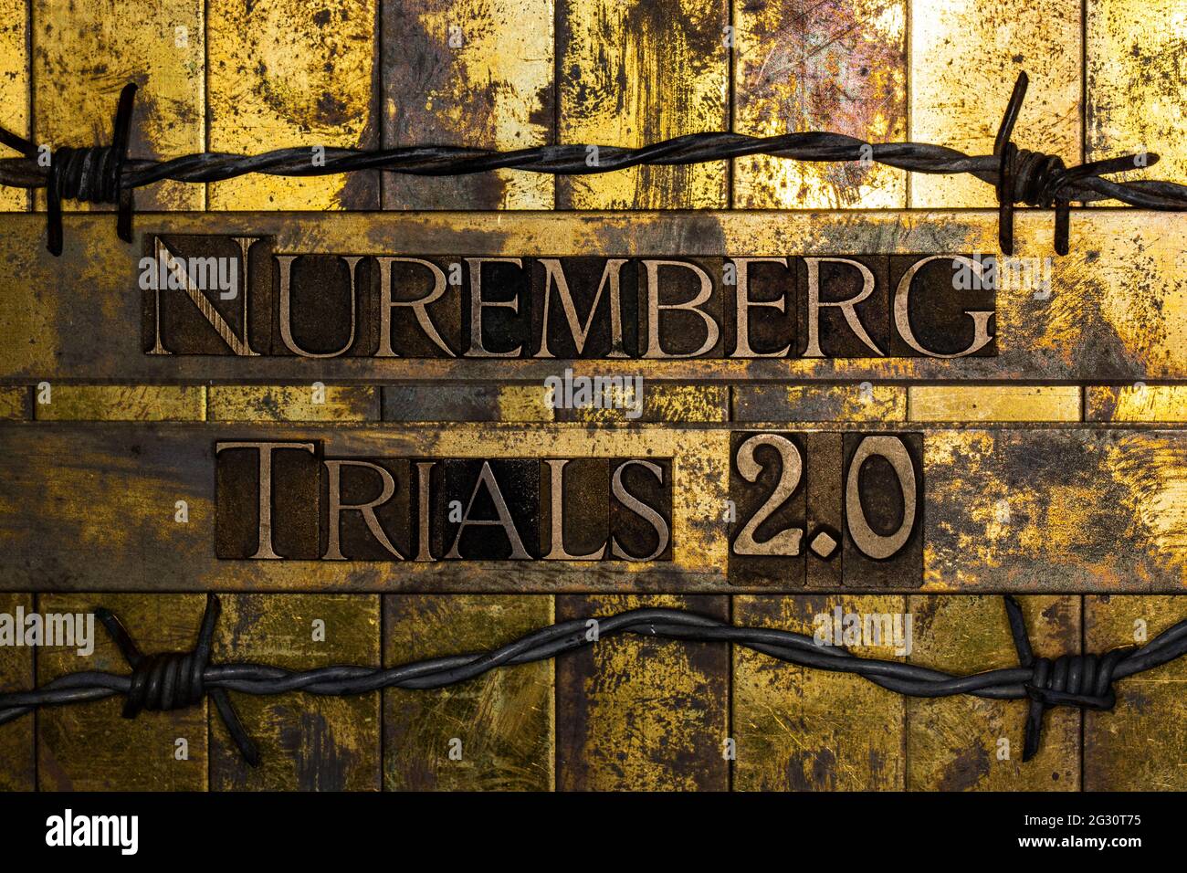 Nuremberg Trials 2.0 text on vintage textured grunge copper and gold bar background surrounded by barbed wire Stock Photo