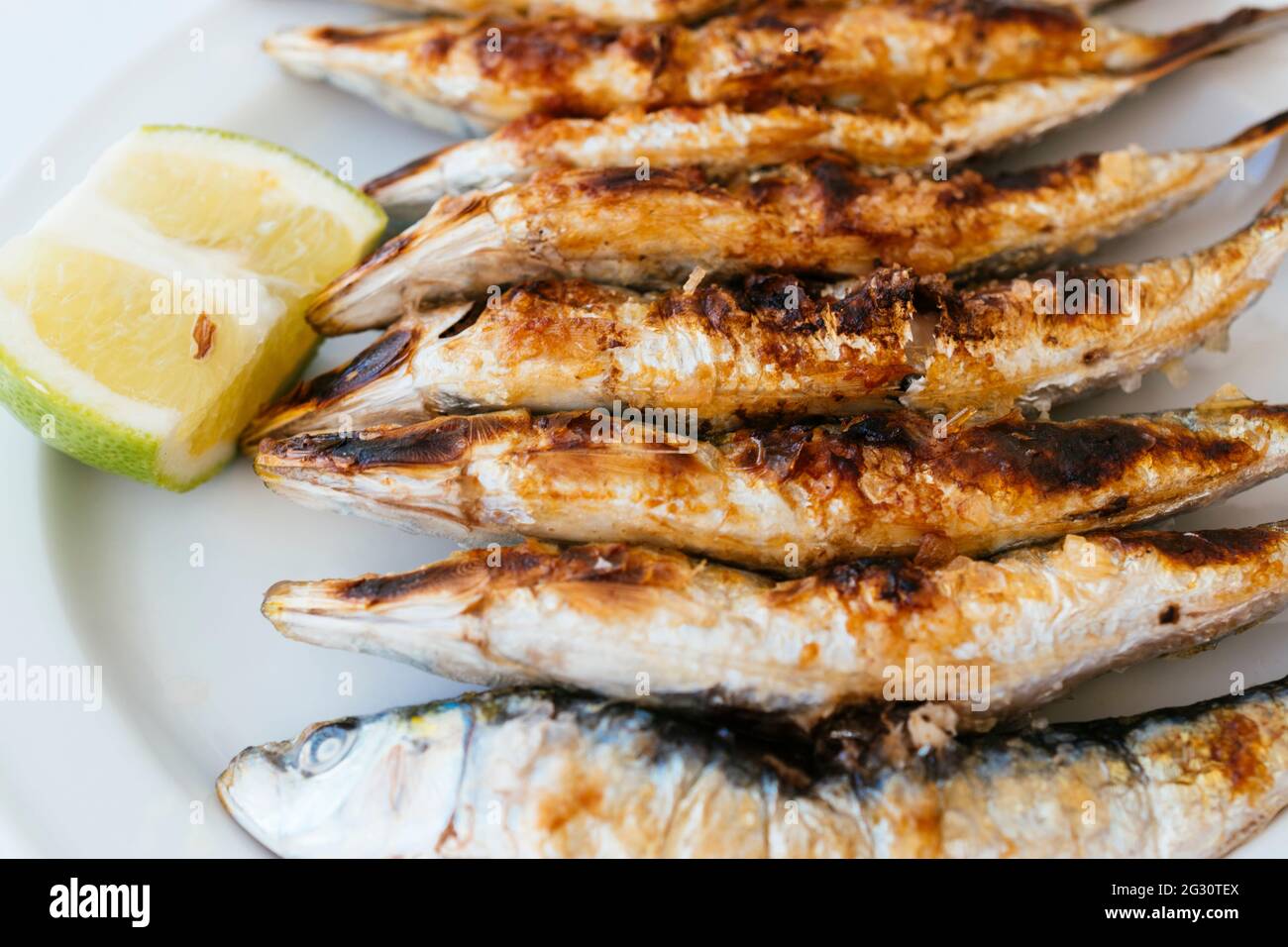 Typical Andalusian food. Grilled sardines - Sardines barbecueing. Torremolinos, Málaga, Andalucía Spain, Europe Stock Photo