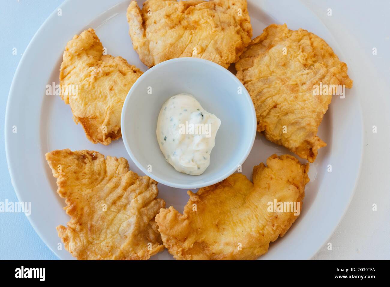 Typical Andalusian food. Rosada fried with aioli. With great popularity in Spain, La rosada, Genypterus blacodes, is not an indigenous fish, it is a s Stock Photo