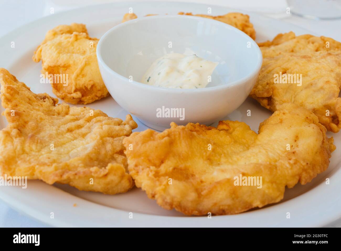 Typical Andalusian food. Rosada fried with aioli. With great popularity in Spain, La rosada, Genypterus blacodes, is not an indigenous fish, it is a s Stock Photo