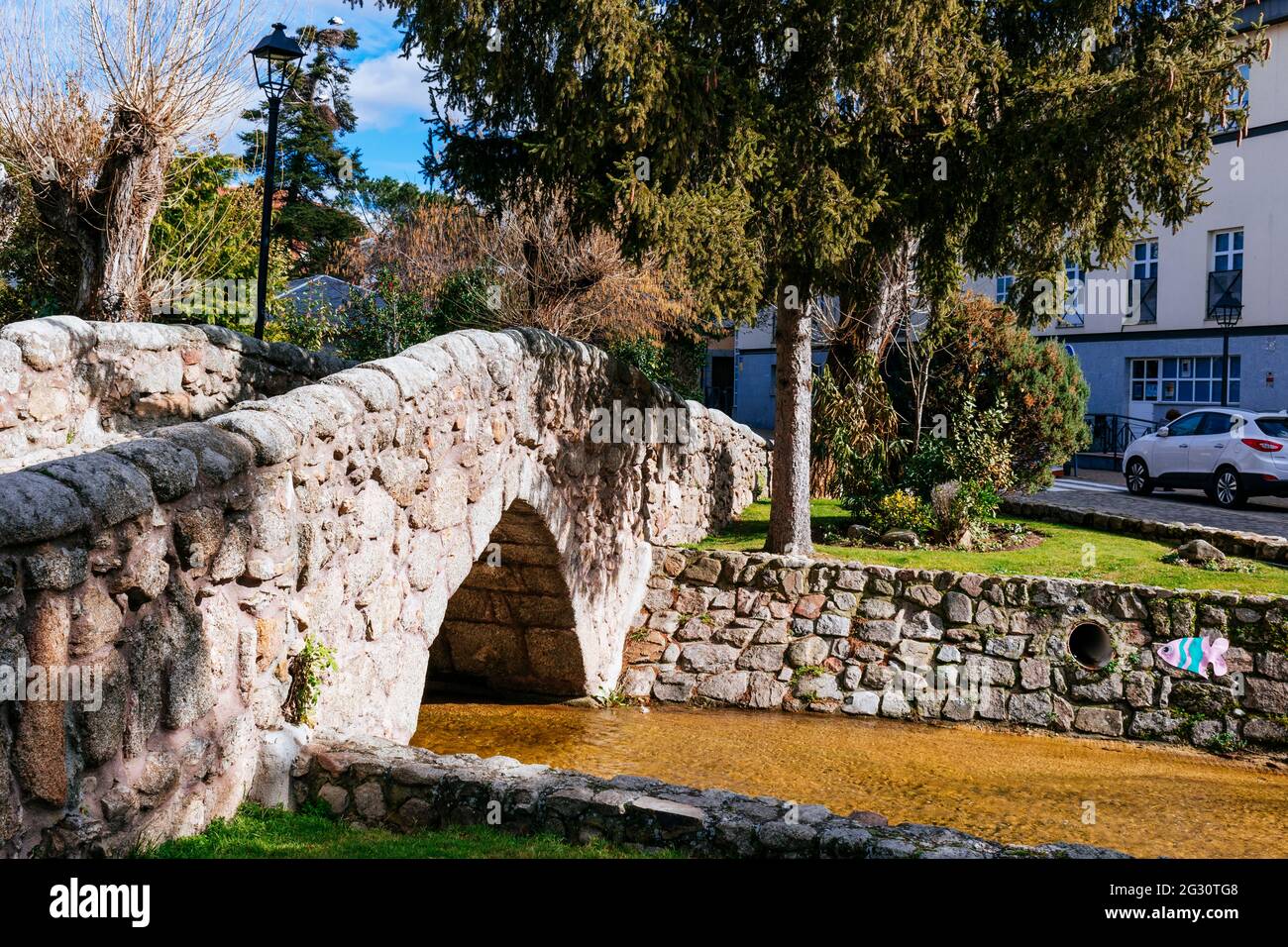 The Romanesque Bridge dates from medieval times and spans the Chozas stream giving access to the Church. It is masonry with granite stone. Soto del Re Stock Photo