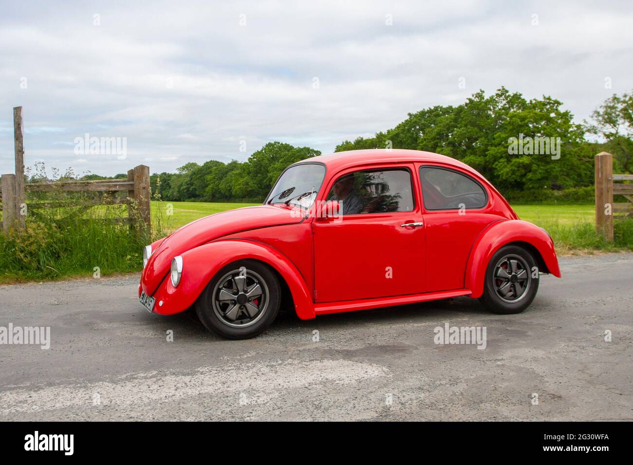 1975 70s red Vw Volkswagen 1200 Beetle, 1300cc petrol , VW Beetles, old  type bug travelling to classic and vintage car show at Heskin Hall,  Lancashire, UK Stock Photo - Alamy
