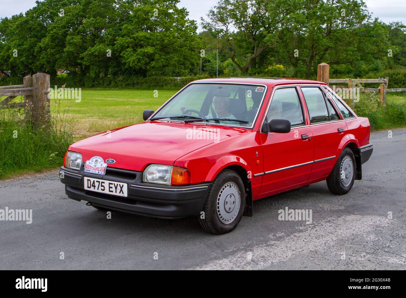 1986 1980s 80s Red Petrol FORD ESCORT  Annual Manchester to Blackpool Vintage & Classic Car Run The event is a Touring Assembly Stock Photo