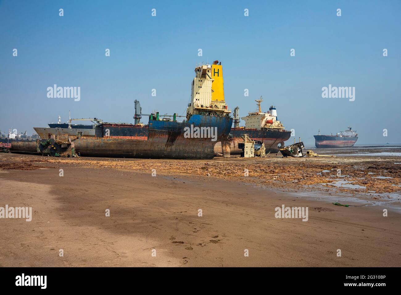 Alang,01,February, 2016: Wide angle view of ship breaking yard with half cut ship and scrap parts and sea in background,Bhavnagar,Gujarat,India Stock Photo