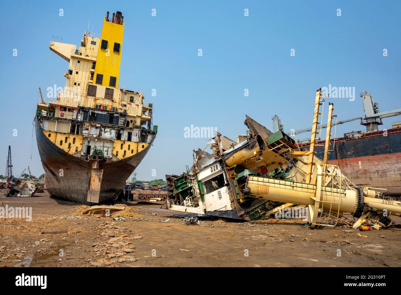 Alang ,01, February,2016: Low angle view of half cut ship with scraped parts and Ship Breaking Yard in background,Bhavnagar Stock Photo