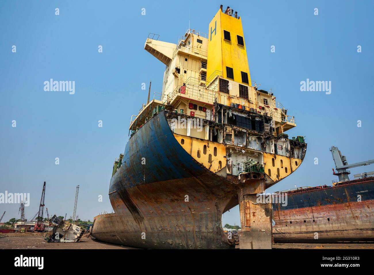 Alang ,01,February,2016: Low wide angle view of cut section of ship in  with cranes and Ship Breaking Yard activities in background,Bhavnaga,r Gujarat Stock Photo