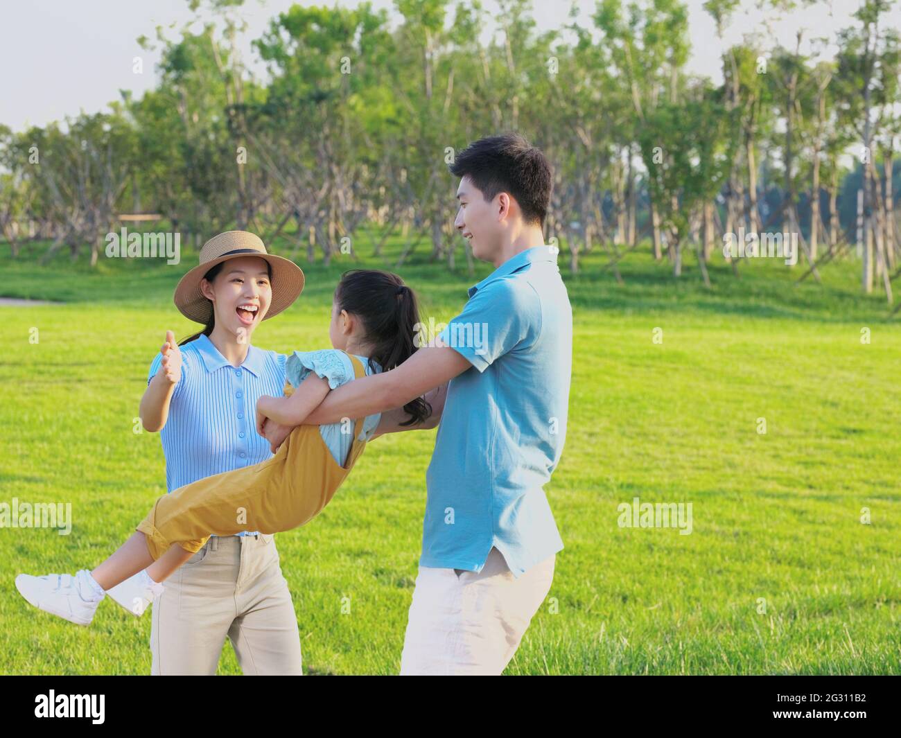 Happy family of three playing in the park high quality photo Stock ...