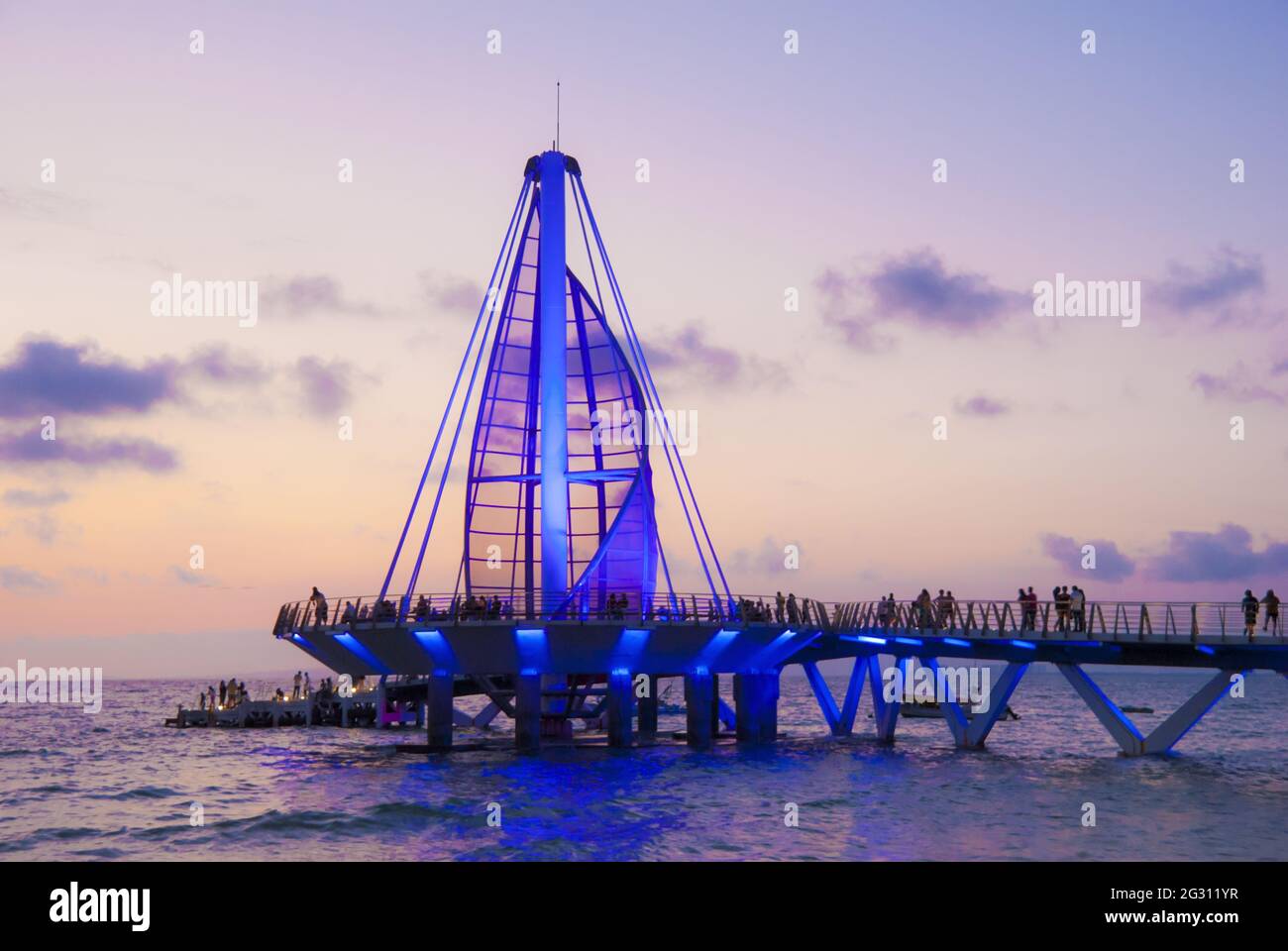 Sail sculpture and pier change colors at night - inaugurated in 2013 and designed by Mexican architect Jesus Torres Vega, the pier features a surface Stock Photo
