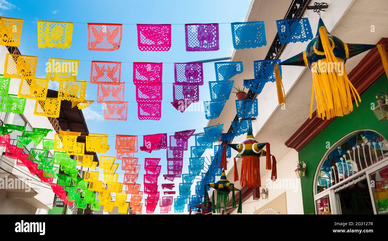 Colorful flags decorate a street in Puerto Vallarta, Jalisco, Mexico Stock Photo