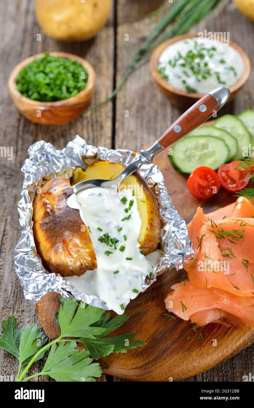 Baked jacket potato fresh from the oven served with chives sour cream
