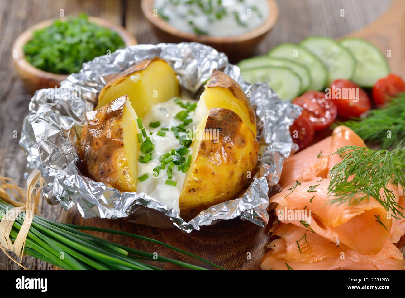 Baked jacket potato fresh from the oven served with chives sour cream