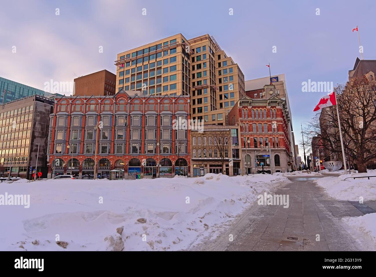 Central Chambers in Queen Anne revival style and modern buildings along Elgin street, covered in snow in Ottawa Stock Photo