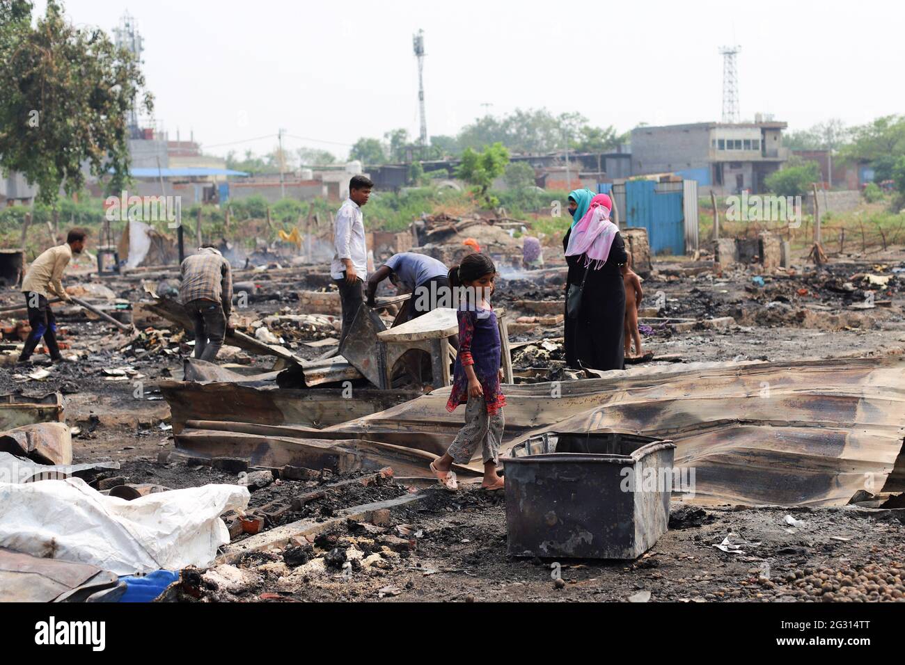 New Delhi, India. 13th June, 2021. A kid seen look around the charred remains of their camp, during the aftermath. A fire incident broke out at the Rohingya refugee camp leaving over 50 shanties of Rohingya refugees gutted. The cause of the fire has not yet been established. Credit: SOPA Images Limited/Alamy Live News Stock Photo