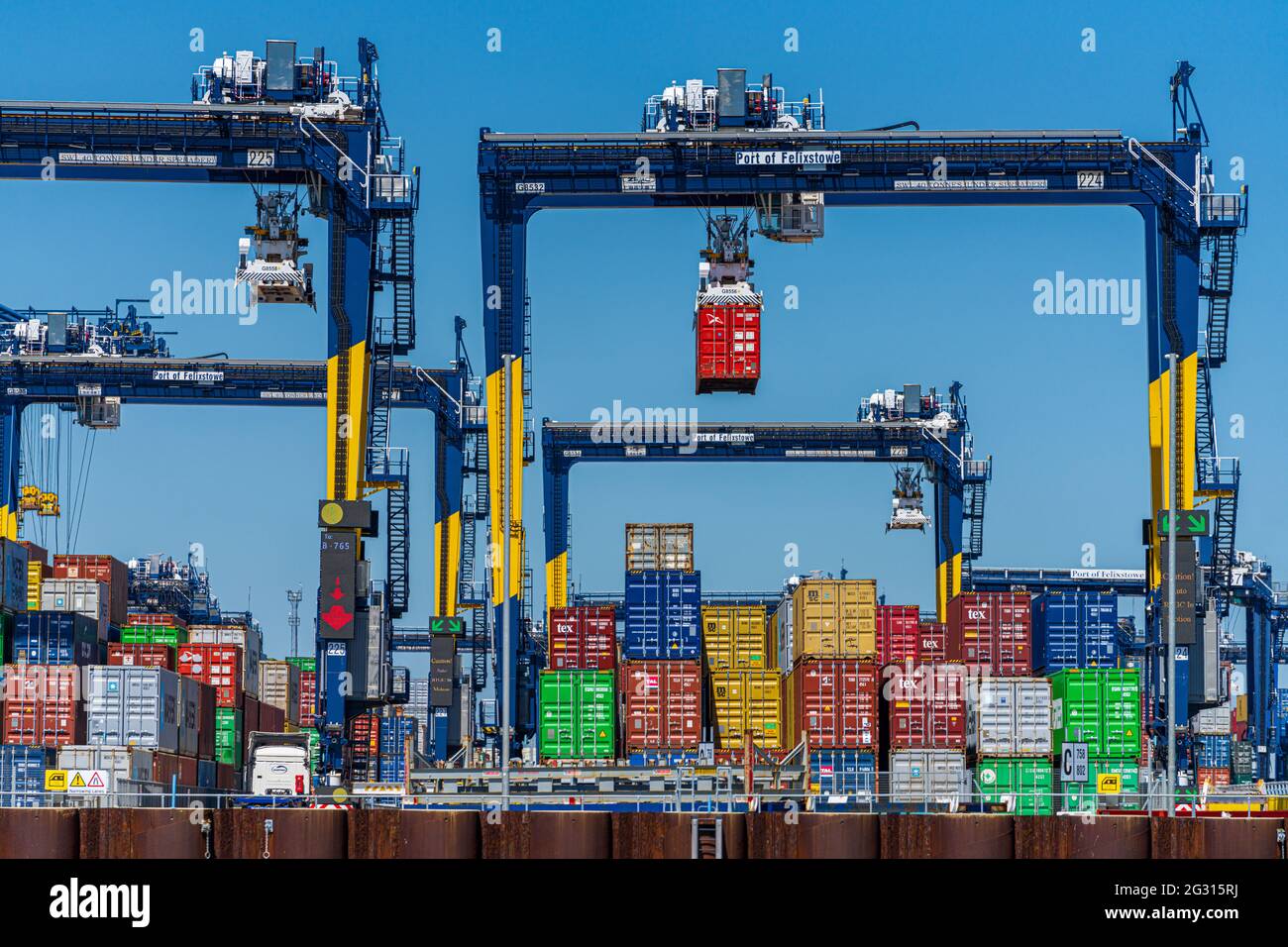 Global Supply Chains - Containers stacked on the dockside at the Port of Felixstowe UK. Global Supply Chain Congestion. Stock Photo