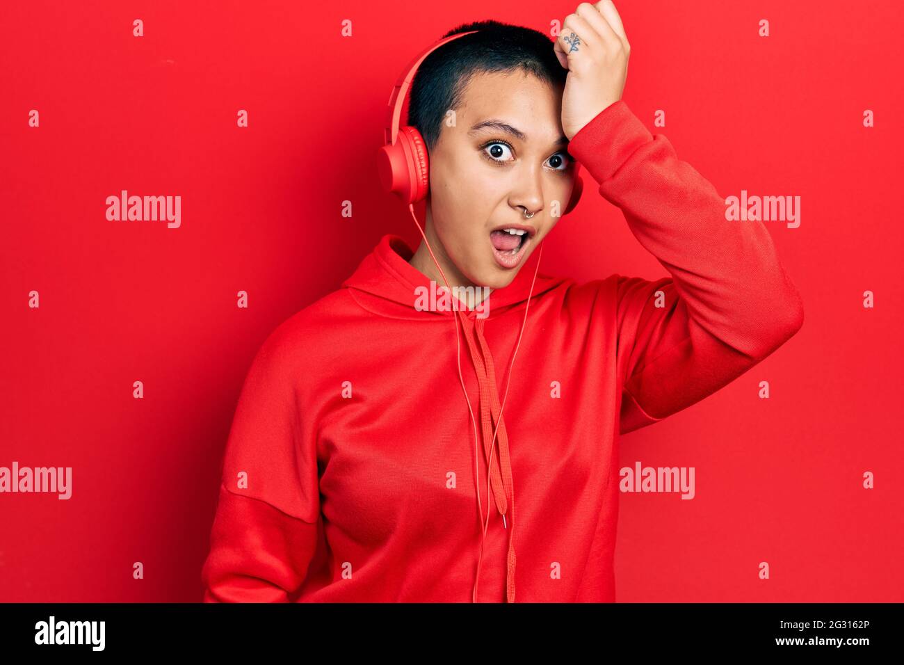 Beautiful hispanic woman with short hair listening to music using