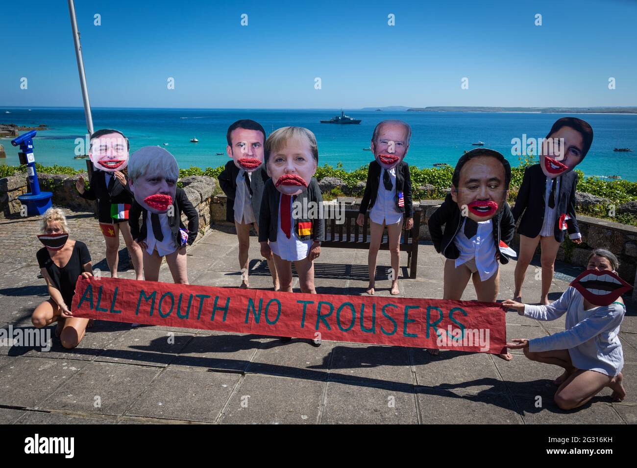 St Ives, UK. 13th June, 2021. XR protesters with cartoon heads of the G7 leaders pose with a banner ÔAll Mouth No TrousersÕ. Extinction Rebellion take action for the third and final day of the G7 Summit. Credit: Andy Barton/Alamy Live News Stock Photo