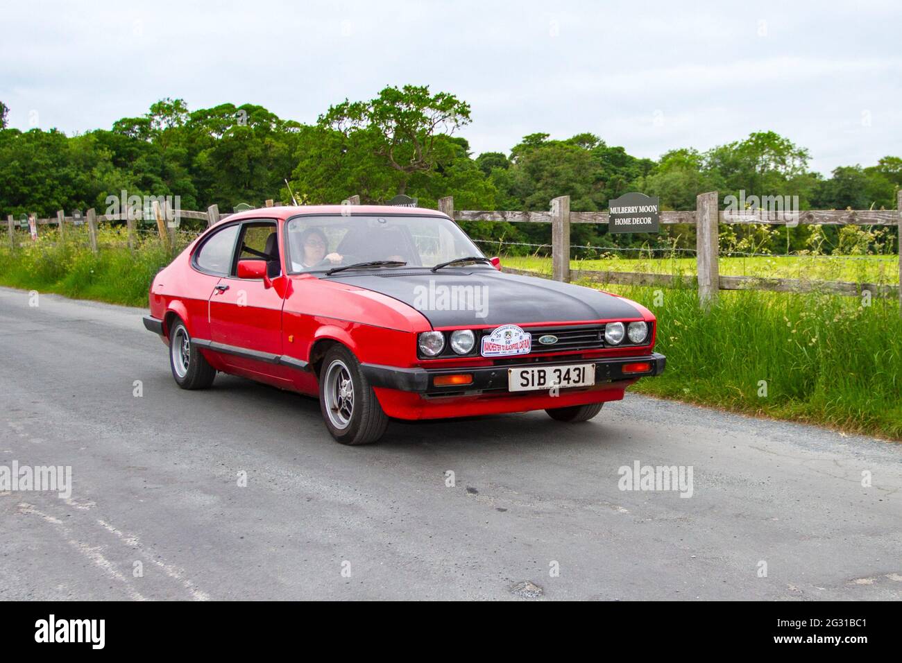 1986 80s eighties red Ford Capri Laser 1993cc petrol hatchback travelling  to classic and vintage car show at Heskin Hall, Lancashire, UK Stock Photo  - Alamy