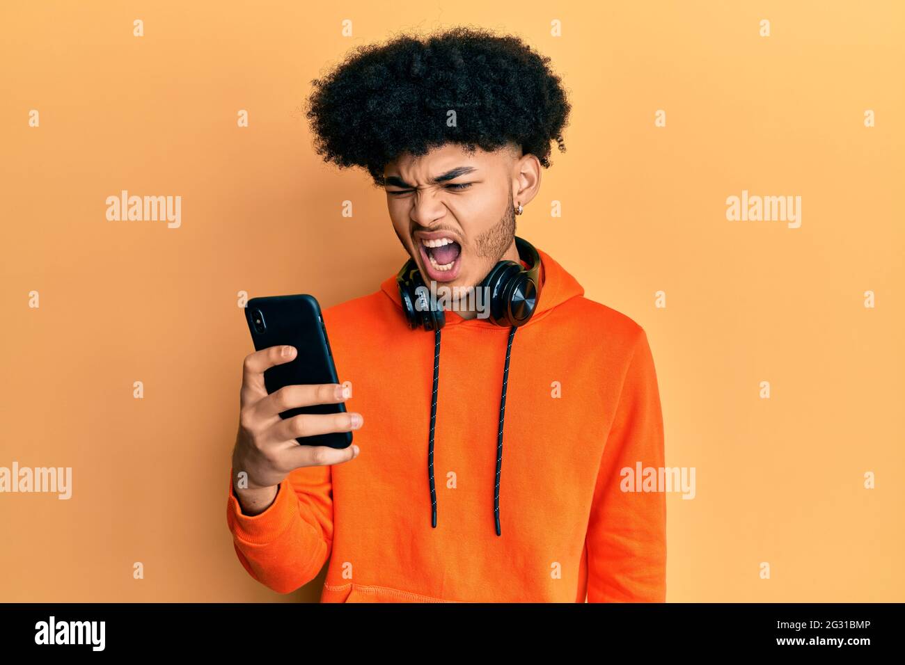 Premium Photo  Handsome bearded guy holds smartphone and plays online games  joyful man wearing a black stylish hat and a blue shirt crazy emotions