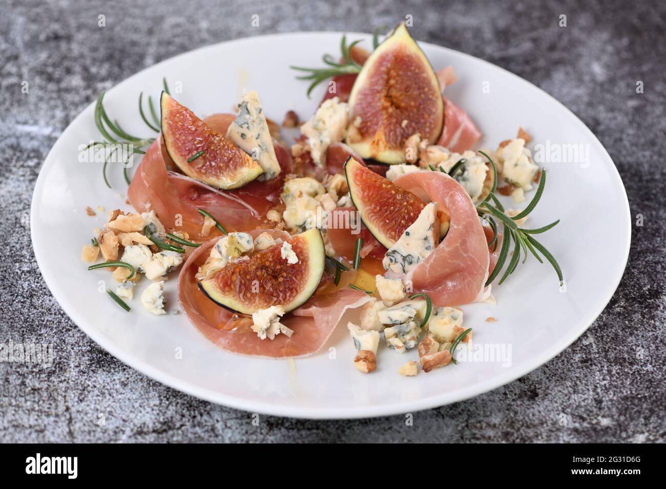 Figs with Parma ham with blue cheese, nuts and honey Stock Photo Alamy