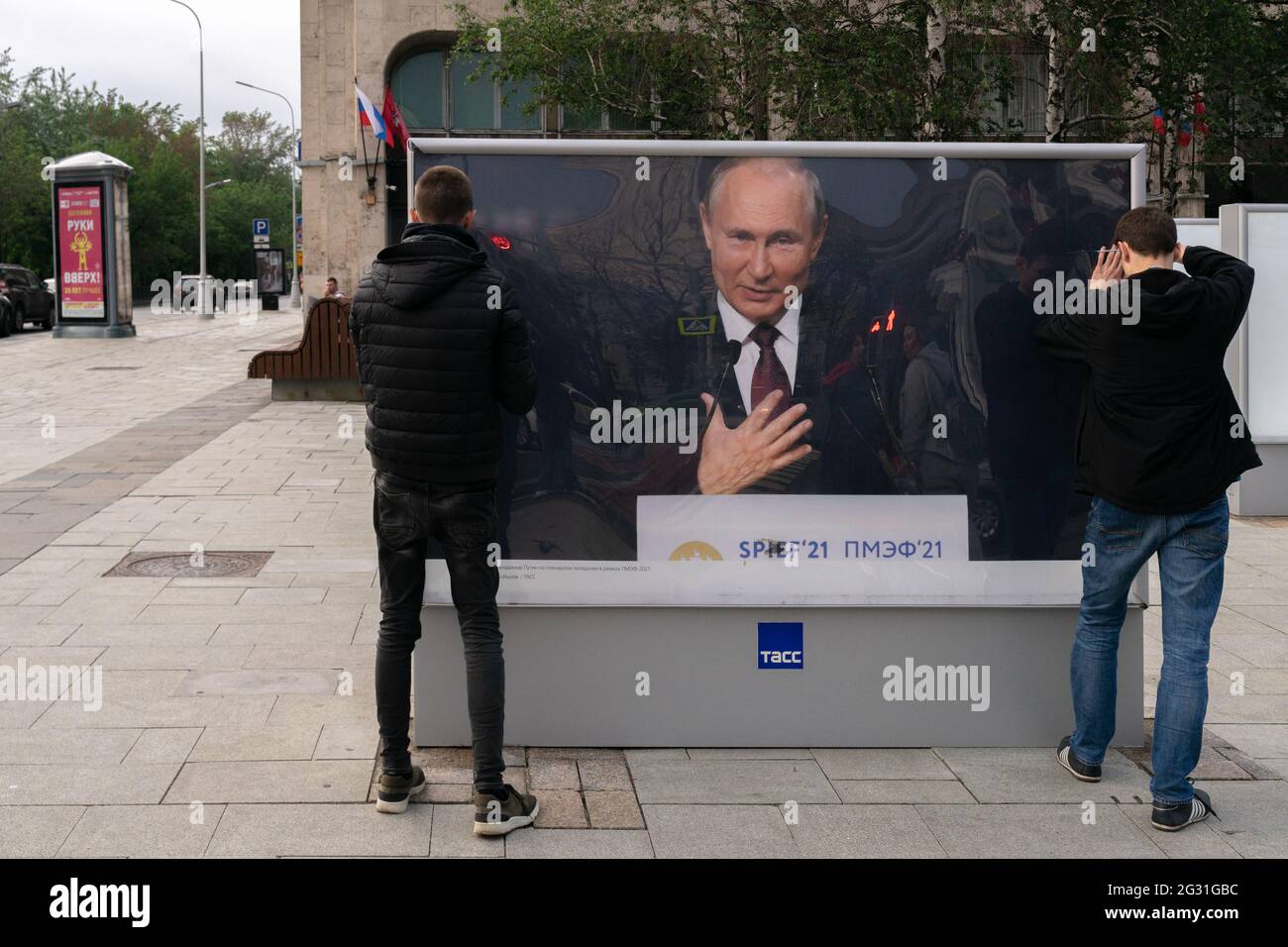 Workers set up display with photo of president of Russia Putin, as part of the out-the-door exhibition on Tverskoy blvd, Moscow, Russia Stock Photo