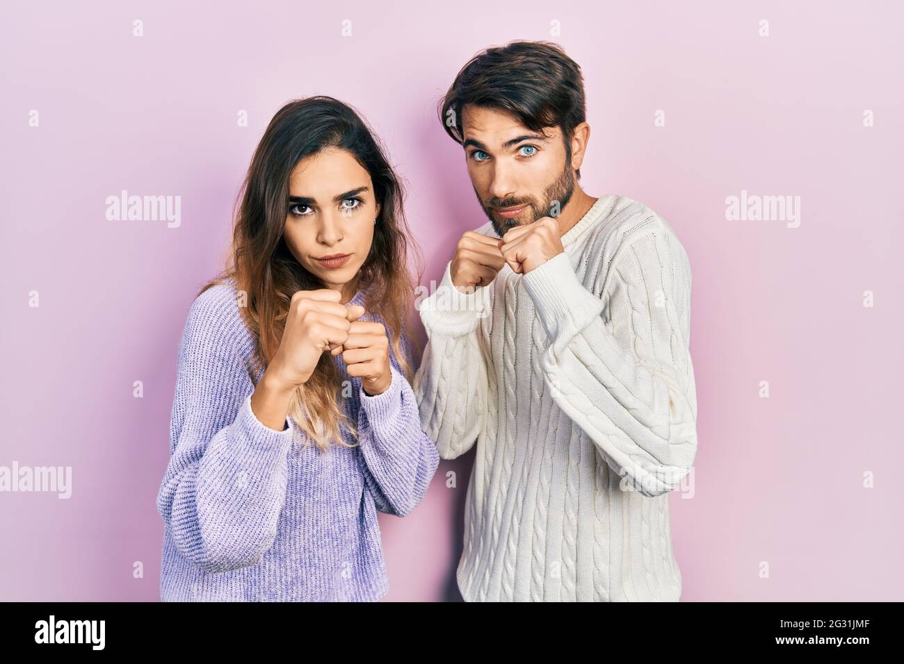 Scared To Fight Young hispanic couple wearing casual clothes ready to fight with fist ...