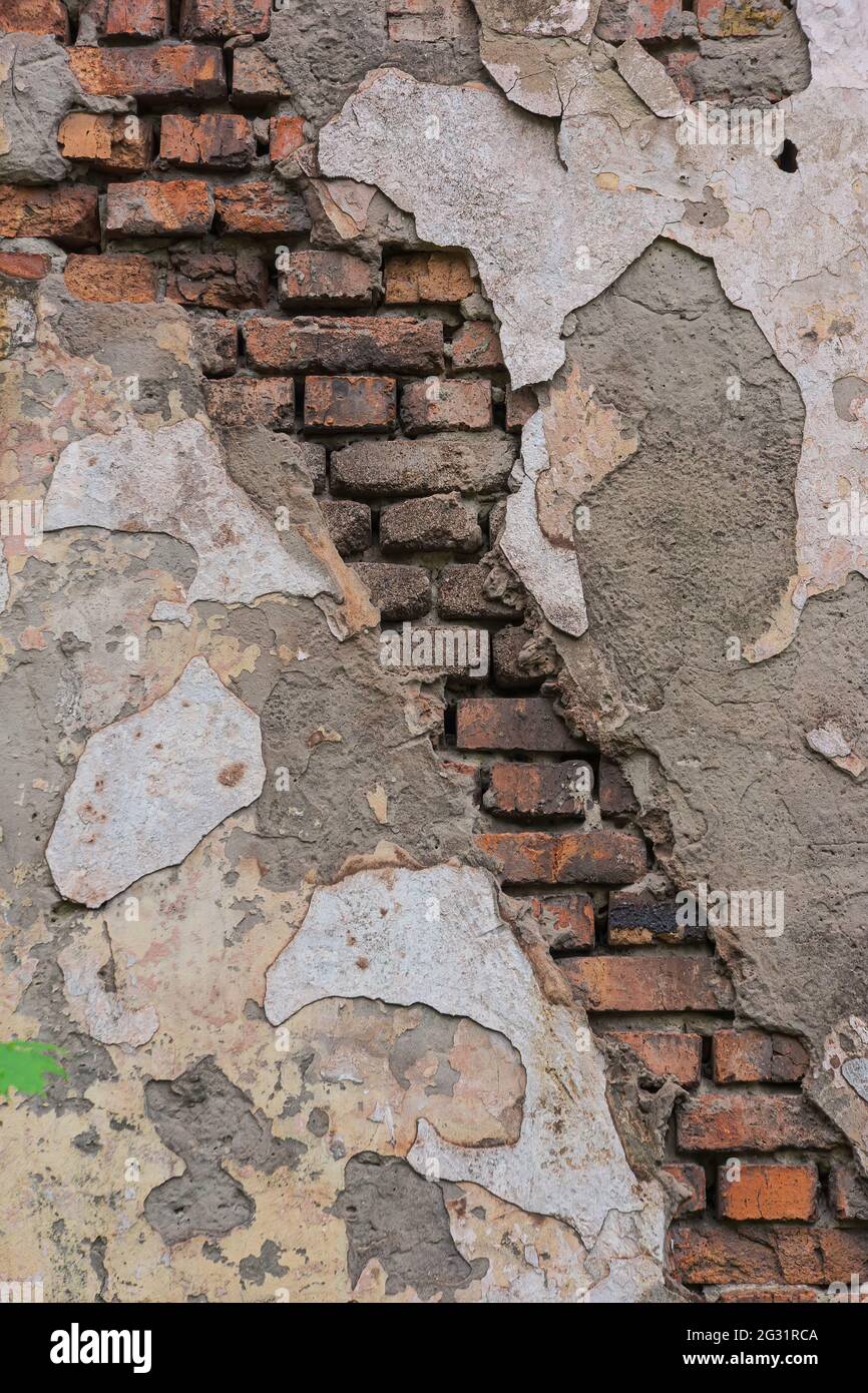 crumbling curtain wall and falling off old cement plaster. Background