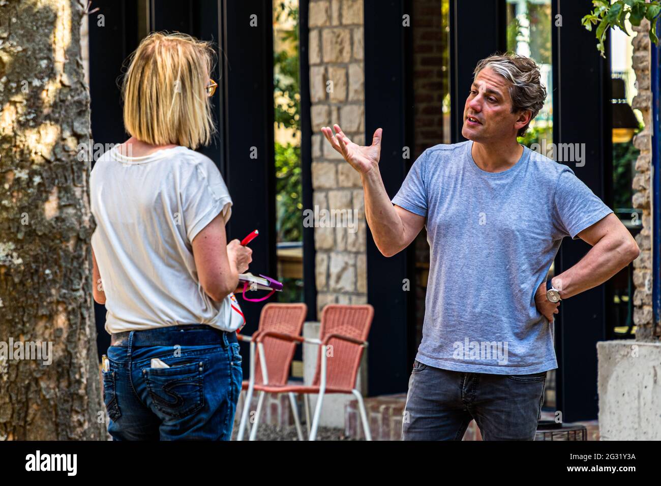 The owner of the Graace Hotel in Luxembourg talking to travel journalist Angela Berg Stock Photo