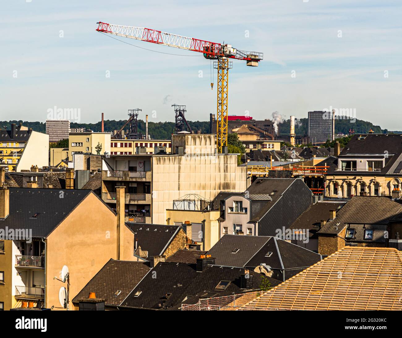 A crane and blast furnaces in the background of Esch-sur-Alzette, Luxembourg Stock Photo