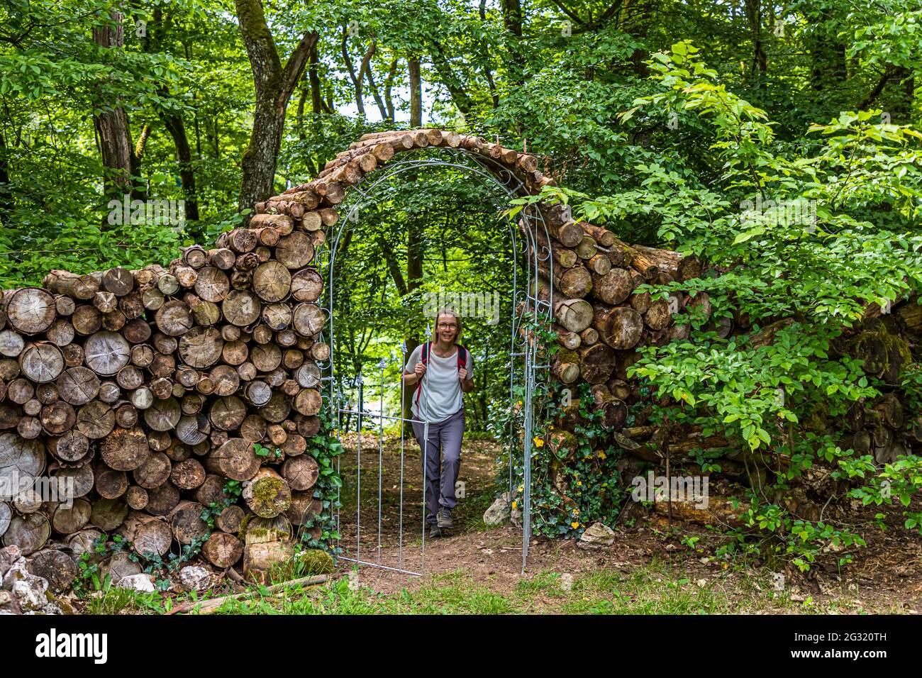 Garden entrance arch from small cut tree trunks in Lipperscheid, Luxembourg Stock Photo