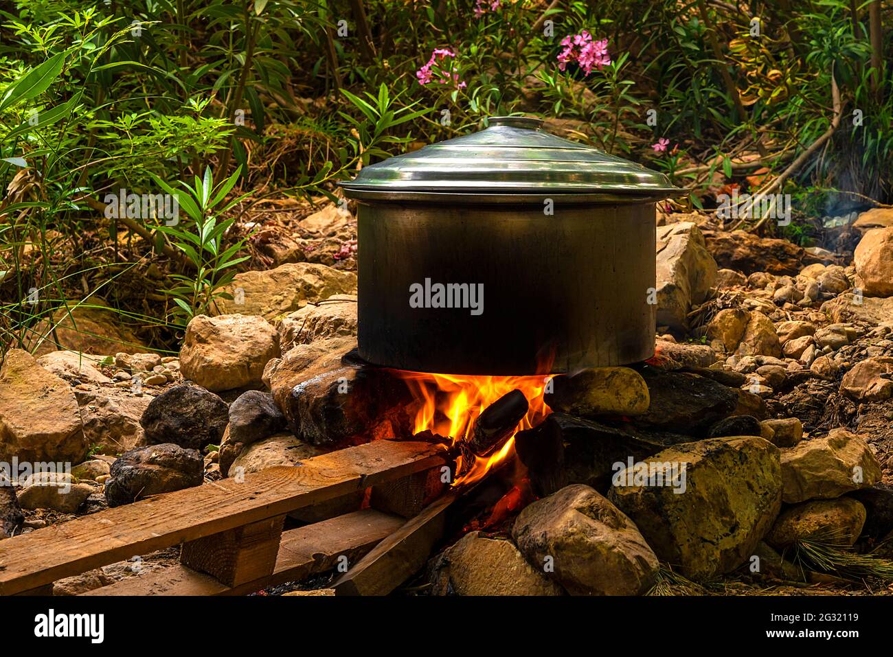 Cooking in a pot over a campfire Stock Photo