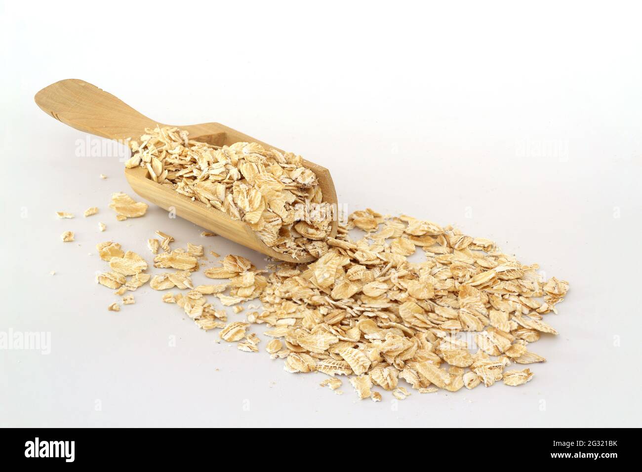 Oat Rocks Oat flakes in wooden spoon isolated on White background. Heap of oats ...