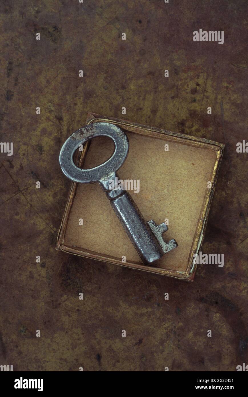 Small cardboard  box containing vintage used silver key Stock Photo