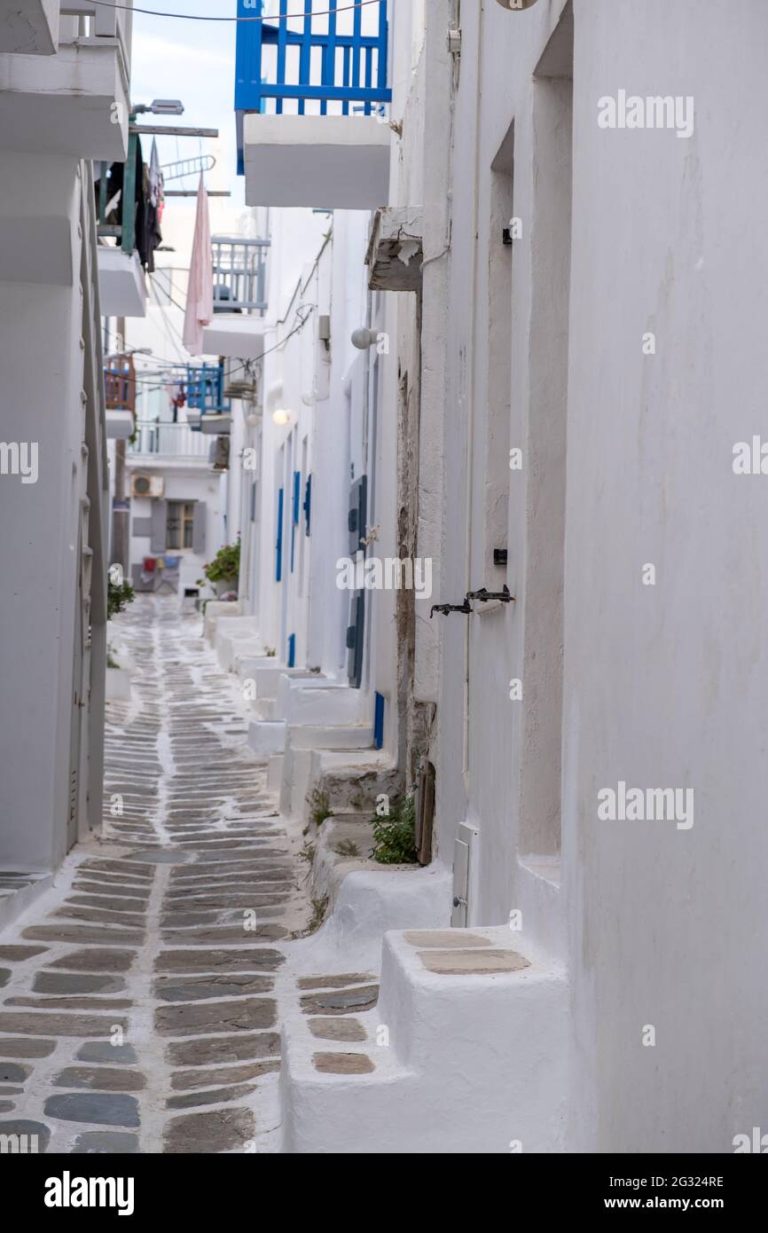 Whitewashed buildings, narrow cobblestone street. Mykonos island ...