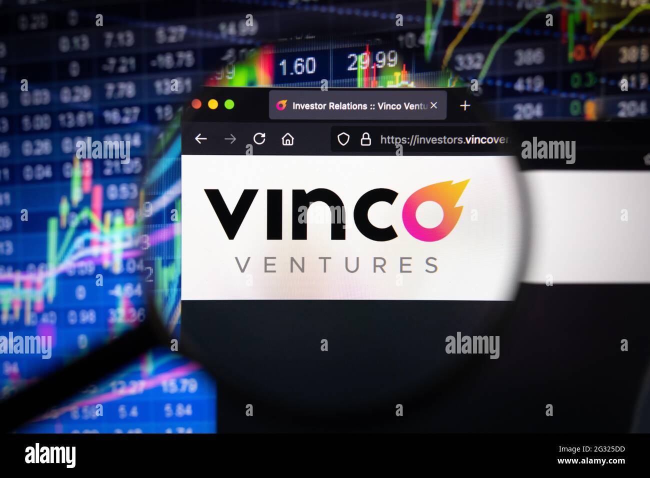 Vinco Ventures company logo on a website with blurry stock market developments in the background, seen on a computer screen through a magnifying glass Stock Photo