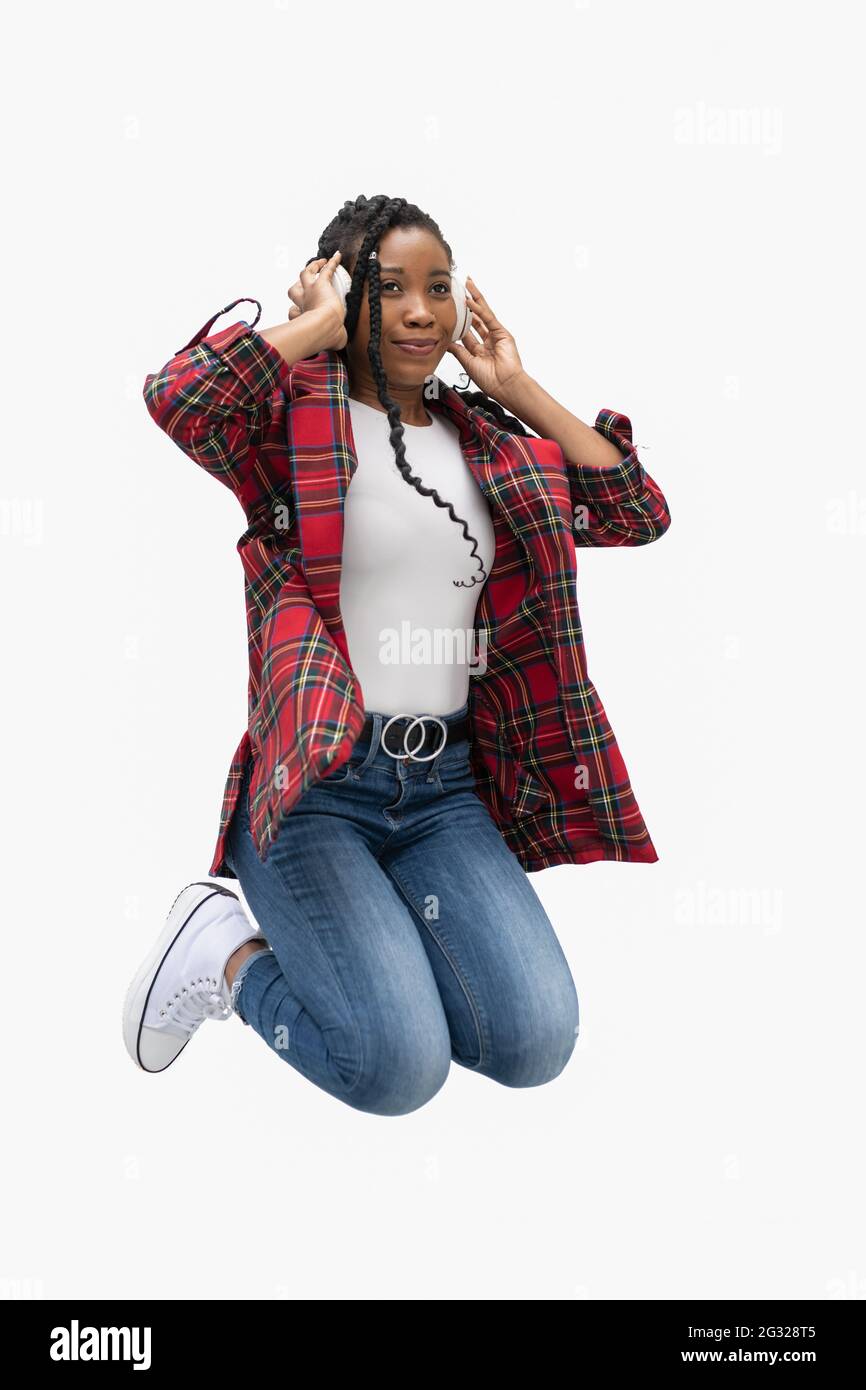 Jumping afro american woman with her arms raised Stock Photo - Alamy