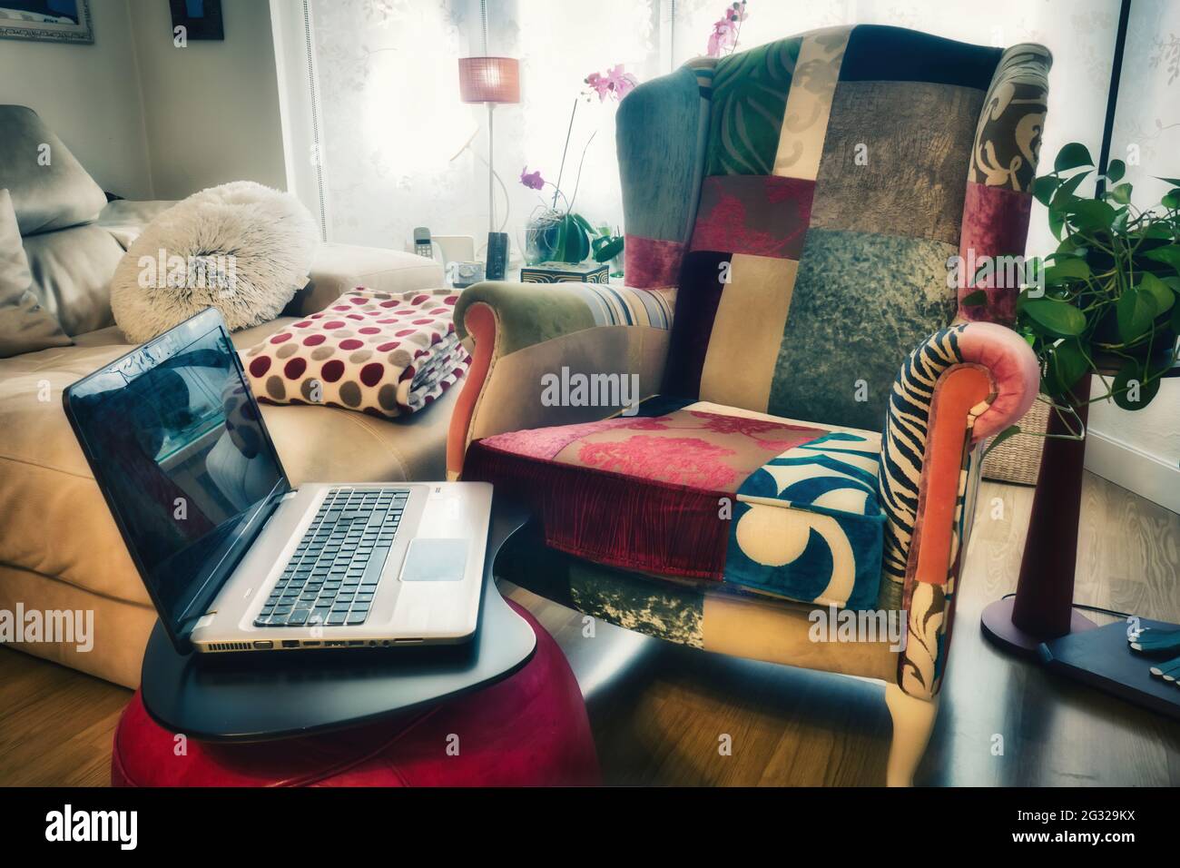 Interior design. Living room of a home with armchair and laptop. Stock Photo