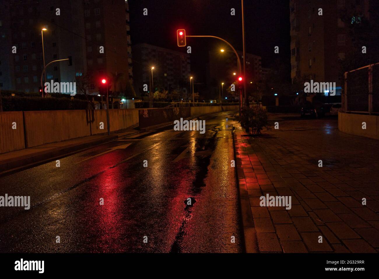 red traffic lights on a rainy day with reflection on wet street at ...