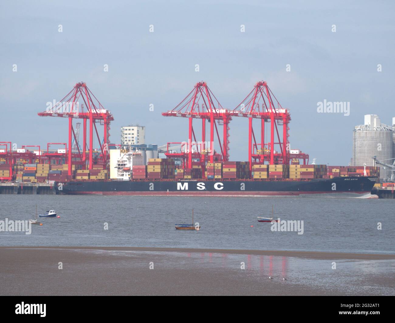 A cargo ship that carries all of its load in truck-size intermodal containers, in a technique called containerization in Liverpool dock Stock Photo