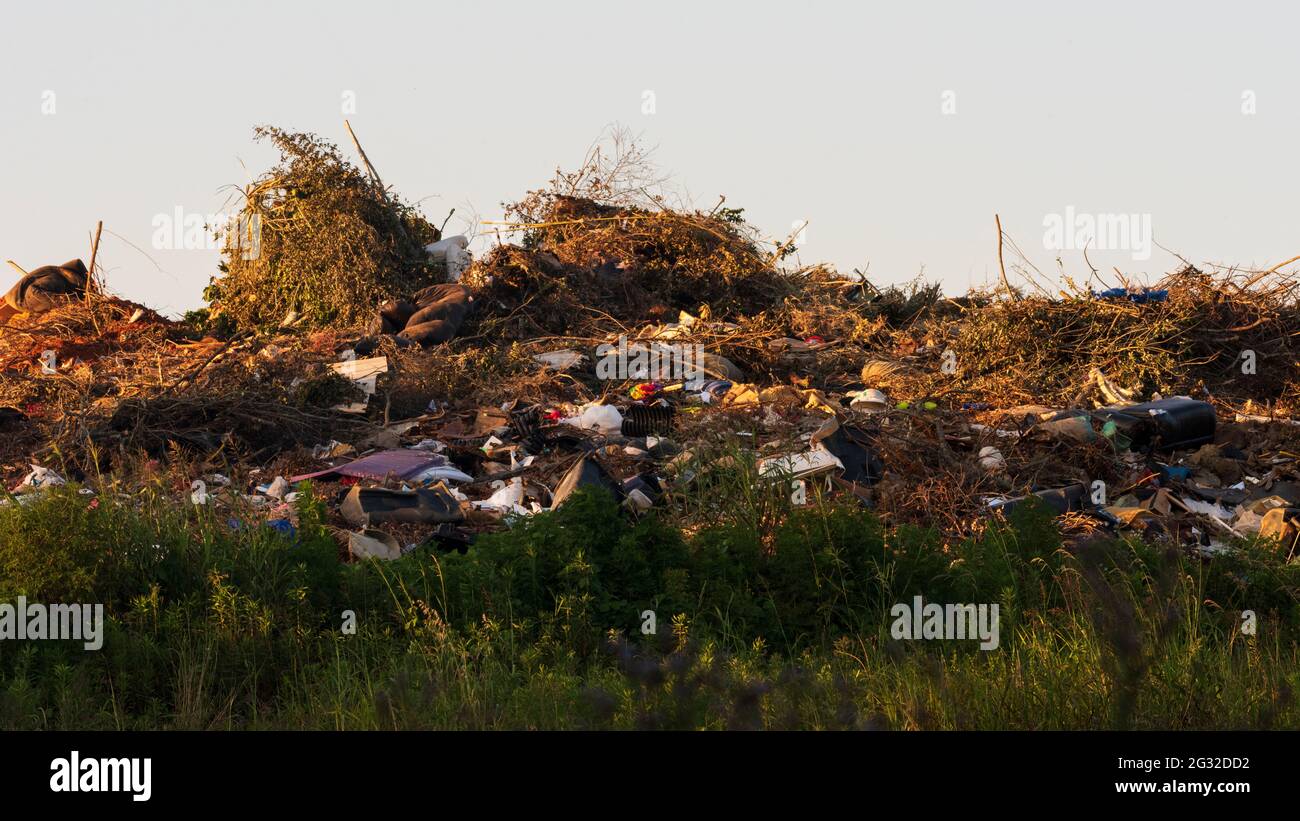 Mounds of garbage create an artificial hill at a dump. Stock Photo