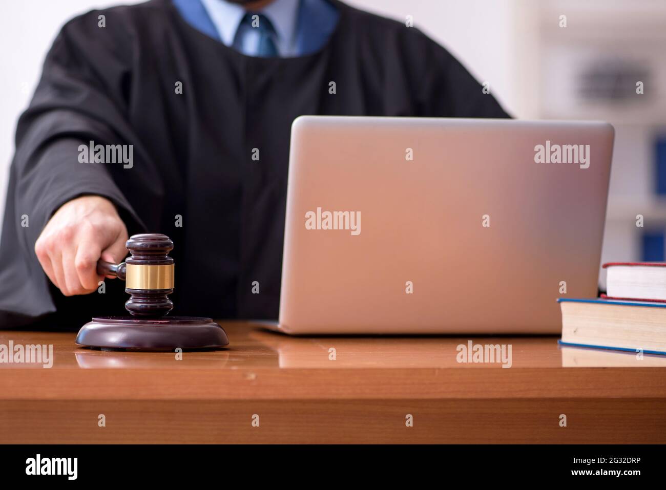 Young judge working in the courtroom Stock Photo - Alamy